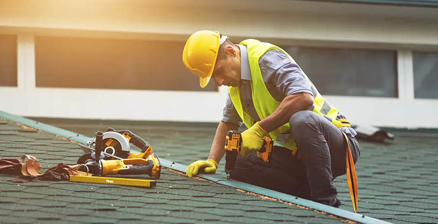 Man drilling on a roof