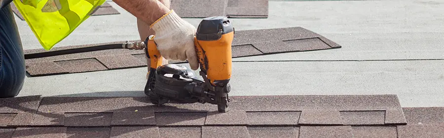 Using a pneumatic nail gun on a roof